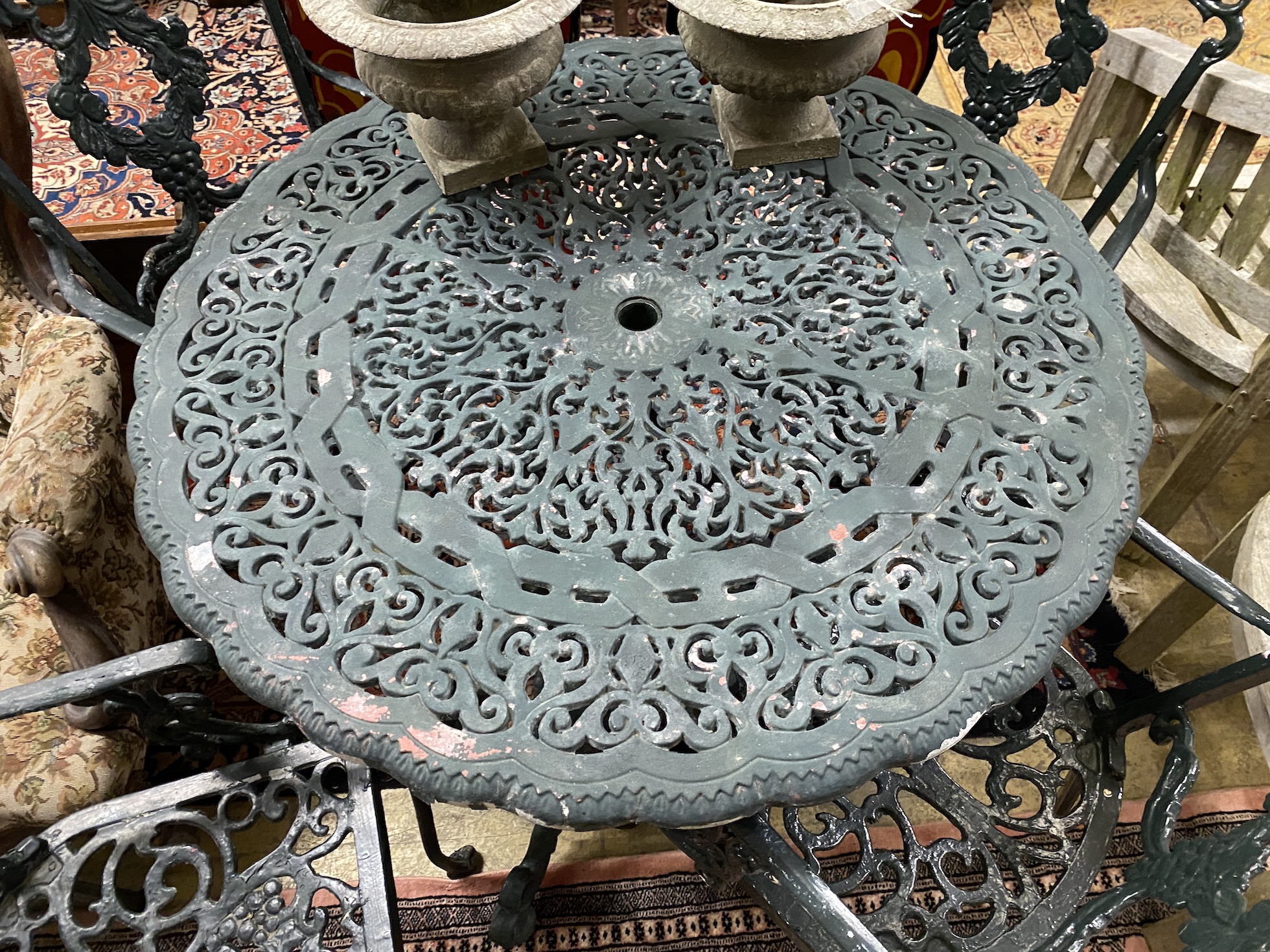 A painted aluminium circular garden table, diameter 92cm, height 72cm and four chairs